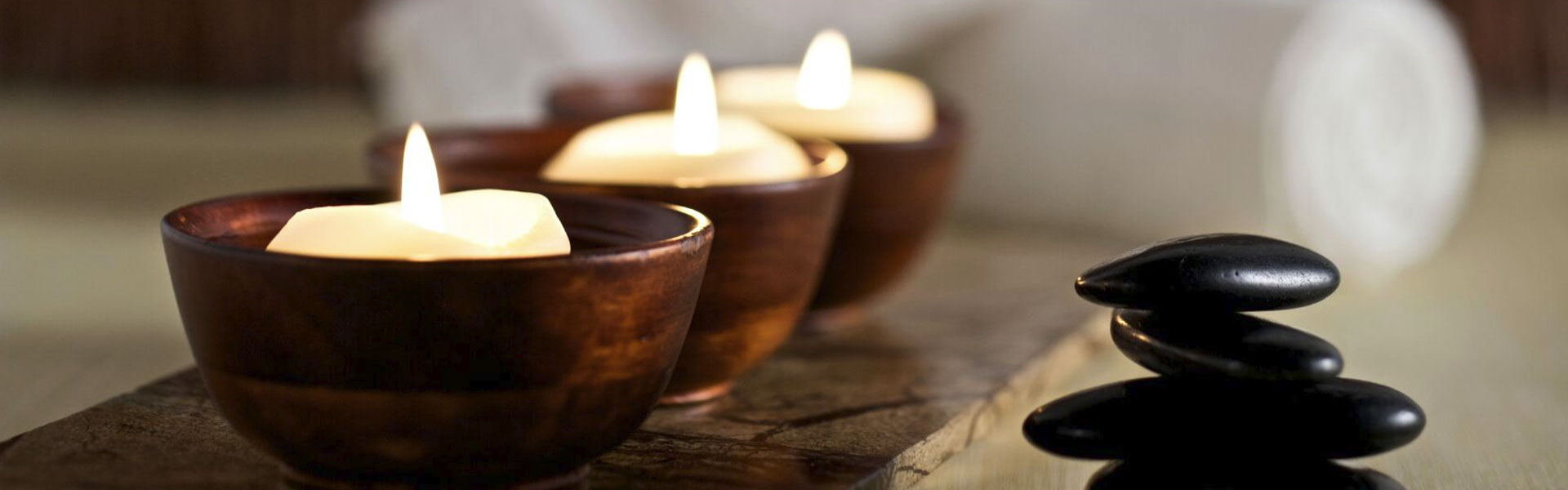 lit candles and stacked rocks at Robvia day spa